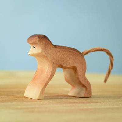 Handmade Monkey wooden toy on a wooden surface.