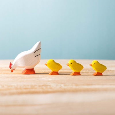The BumbuToys Wooden Chicks incorporated into a farmyard play scene with other wooden animals and accessories.