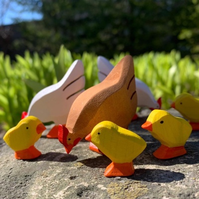 Wooden Chicks nestled among colorful blocks as part of a mixed play scene.