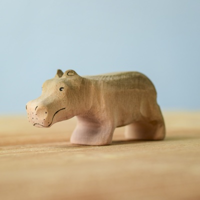 Handcrafted wooden Hippo Baby toy on a wooden table.