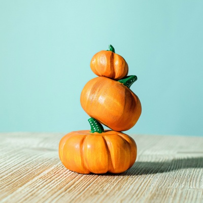 Artisanal wooden pumpkins by BumbuToys, capturing the vibrant spirit of the fall season