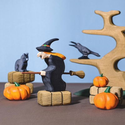 A child holding the raven and cheese, placing them playfully together.