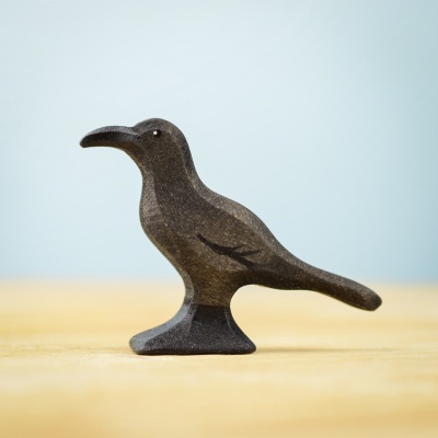 Handcrafted wooden raven toy, minimalist design.