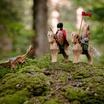 A child's hand holding the Michael the Brave figure, showcasing the size and craftsmanship of the toy.
