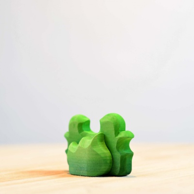 Lush green wooden shrub toy, perfect for nature-themed playsets.