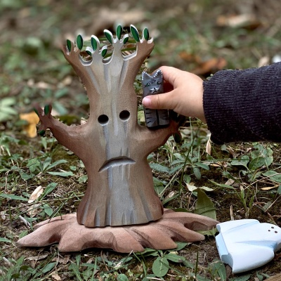Child playing near the Spooky Tree Big, enhancing a haunted theme