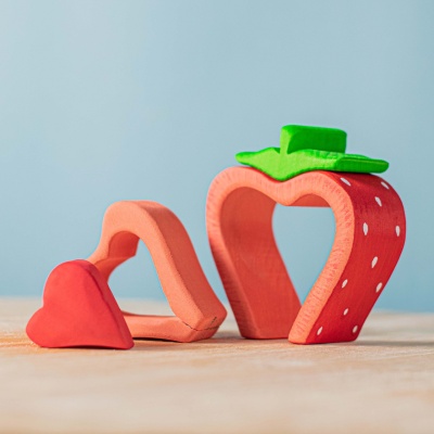 A vibrant red strawberry with a green top, a BumbuToys' hand-painted delight.