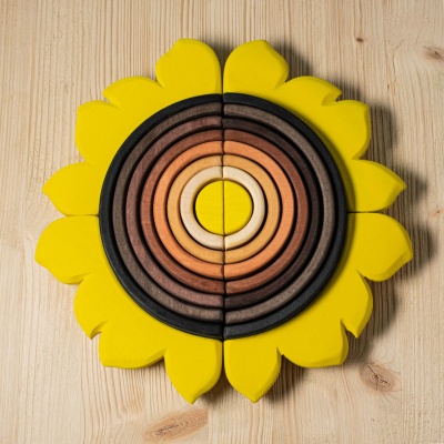 Layered wooden discs create a sunflower's heart in this BumbuToys creation.
