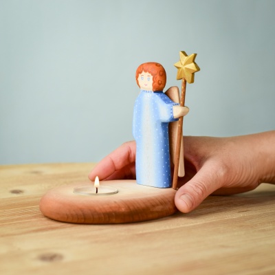 Close-up of a hand holding the Angel Figurine Candle Holder, showcasing its size and craftsmanship.