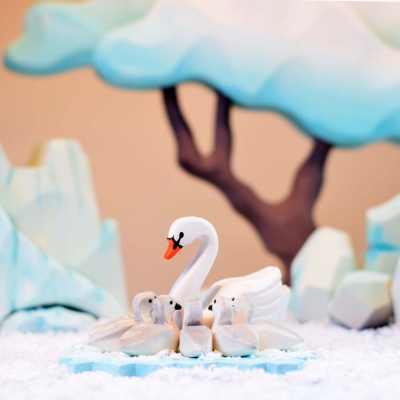 Romantic swan figures from Bumbu Toys, adrift on a wooden symbol of the heart.