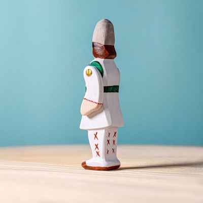 Peasant toy displayed on a child's bedroom bookshelf