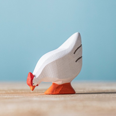 Image of the BumbuToys White Hen standing alone on a natural wood surface.