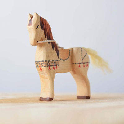 Image of the Steed wooden horse displayed on a shelf in a child's room.
