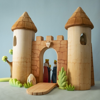Castle toy setup with king and queen figures standing at the gate.