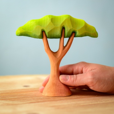 Hand holding the Small Acacia Tree wooden toy.
