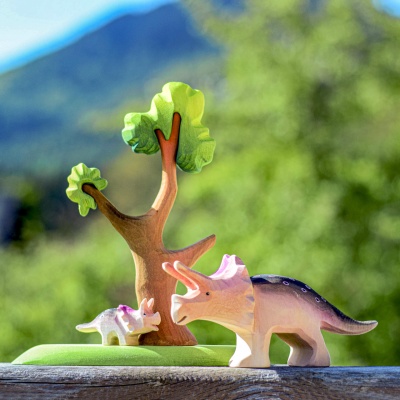 Wooden tree in a nature-themed play setup with dinosaurs