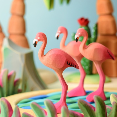 Group of Flamingo wooden toys in a vibrant play scene.