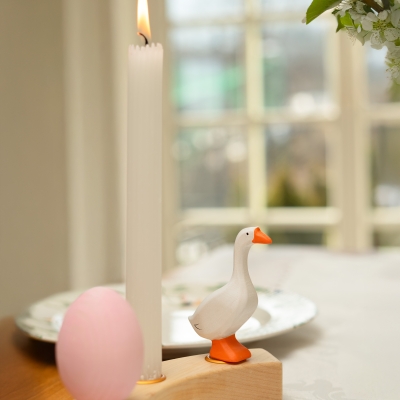 Playful wooden farm scene with a pink blossoming tree, houses, bunnies, a hen, and a white goose toy