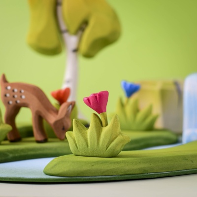 Grass with Pink Flower Small in a nature-inspired play setup with animals.