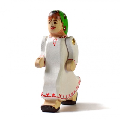 Close-up of wooden girl figure with hand extended towards lake