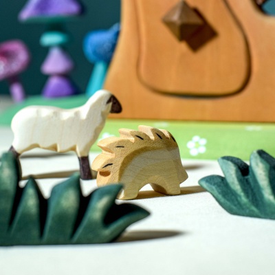 A child using the lamb figurine to create a story alongside other animal figurines.