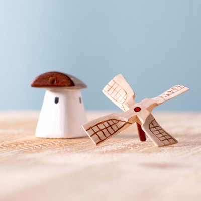 The windmill displayed on a windowsill, bathed in sunlight.