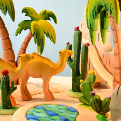 Wooden prickly pear cactus with camels and desert landscape