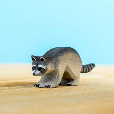 Wooden raccoon figure in a crouching position, beautifully crafted by Bumbu Toys