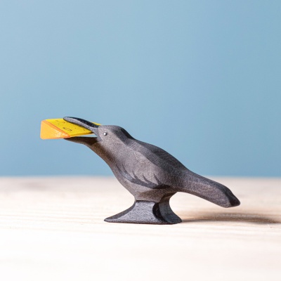 Close-up of the raven, showcasing its hand-painted features and mischievous expression.