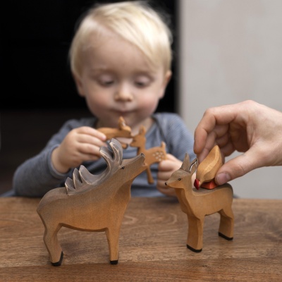 A gathering of wooden deer, a tribute to forest life by Bumbu Toys.
