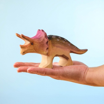 Hand holding Wooden Triceratops Big for size reference