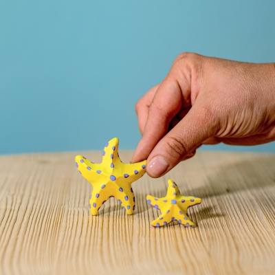 Child's hands exploring the textures of the Yellow Starfish Set
