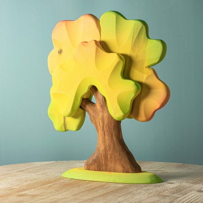 The hand-painted Large Oak Autumn toy from BumbuToys, mirroring the vibrant colors of the season.