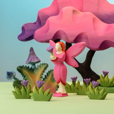 Handcrafted wooden Blossom Fairy in a pink dress surrounded by flowers and trees by Bumbu Toys