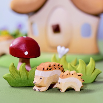 The toy photographed beside other BumbuToys wooden animals, showcasing the collection.