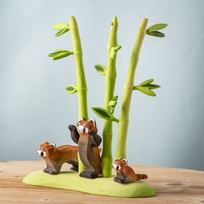 Complete red panda family and bamboo tree play scene