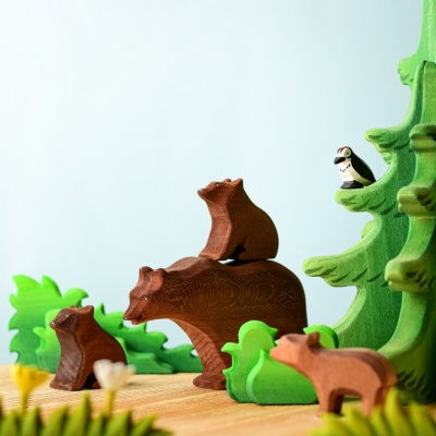 Wooden bear family with woodland background
