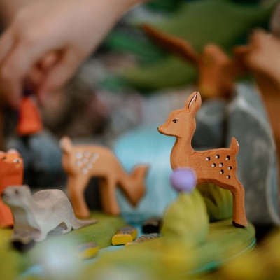 A child drawing a picture of the fawn toy, inspired by its design.