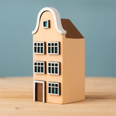 Handmade wooden Haarlem House in beige with white roof trim.