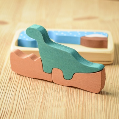 Close-up of the intricately cut dinosaur puzzle pieces, emphasizing their smooth wooden edges.
