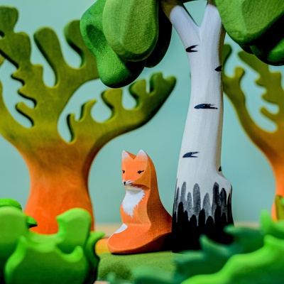 The fox figurine integrated into a pretend play scenario with other animal figurines.