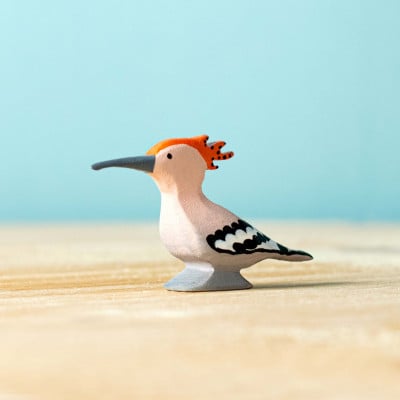 Close-up image of the hoopoe's head, highlighting its hand-painted beak, eye, and unique crest feathers.