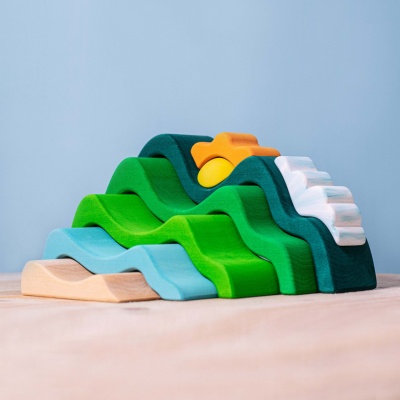 Wooden layers of green hills and a bright sun by BumbuToys, for imaginative exploration.