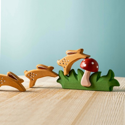 The mushroom being used in a color sorting activity with other red toys.