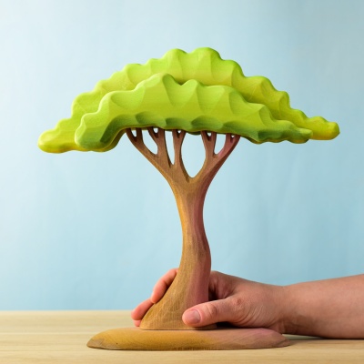 Hand holding the Large Acacia Tree wooden toy.