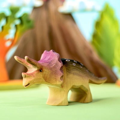 Wooden Triceratops in dinosaur-themed playset