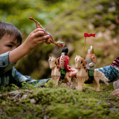 Child's hand interacting with the figures, demonstrating playability and scale.