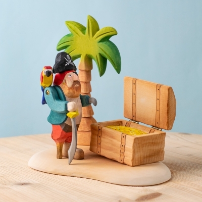 Complete wooden pirate playset with pirate, palm tree, and treasure chest on Sandy Island base