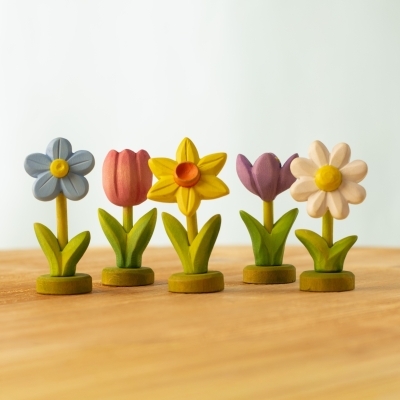 Close up of a green wooden display base for Waldorf spring flowers