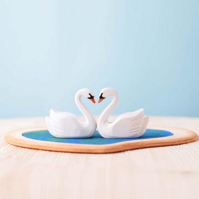 The artistry of affection in Bumbu Toys' swans on a heart-shaped lake.